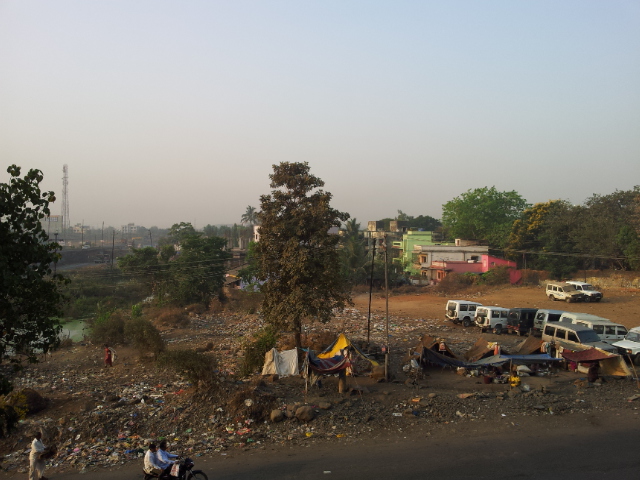 The morning scene from the Hotel in Shahapur; across the street families live in makeshift homes amongst the rubbish. Poverty is never far away. 